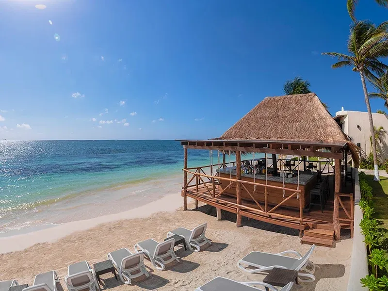 White-sand beach and oceanfront terrace at Desire Riviera Maya Resort