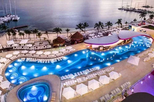 Aerial view of the illuminated Sexy Pool and Caribbean shoreline