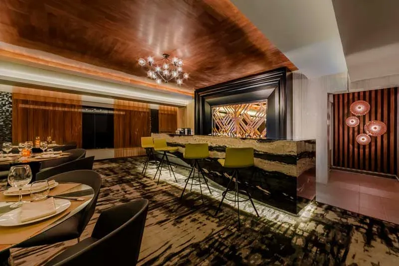 Dark wood dining room and bar inside Suki restaurant